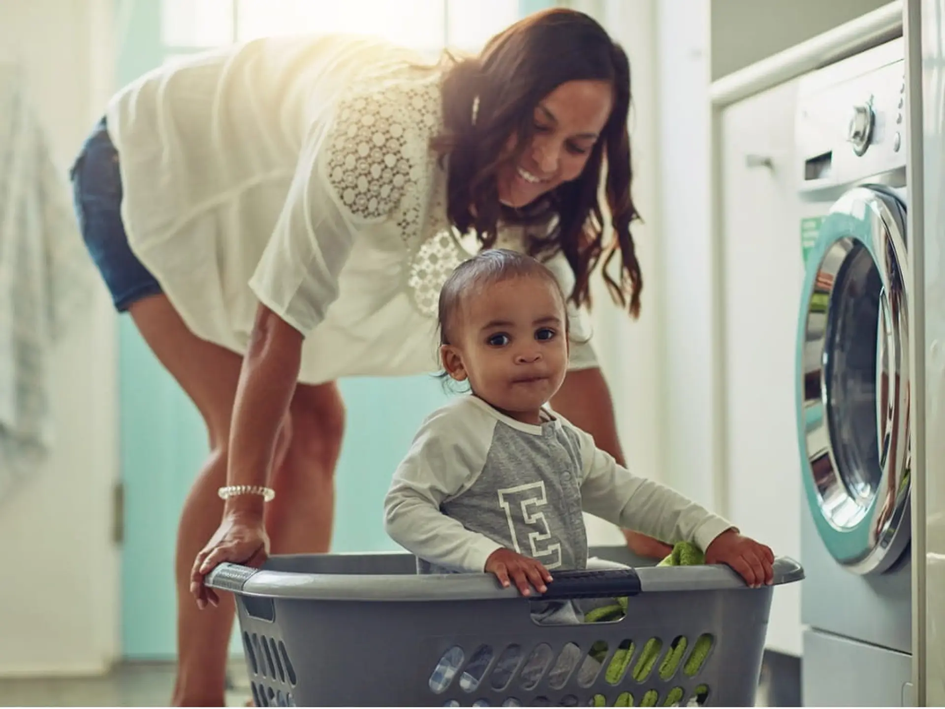 kid in laundry basket