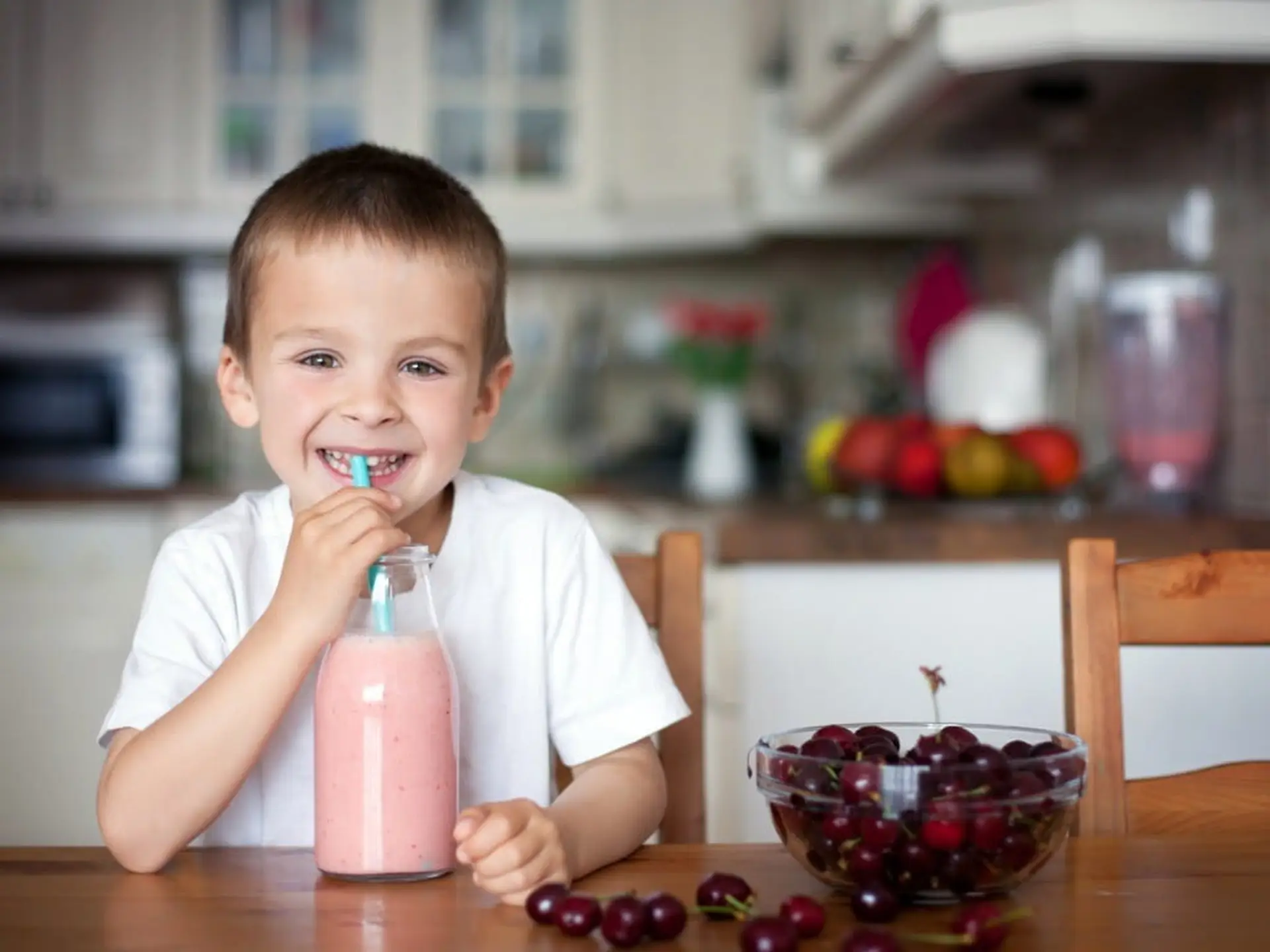 boy drinking cherry smoothie