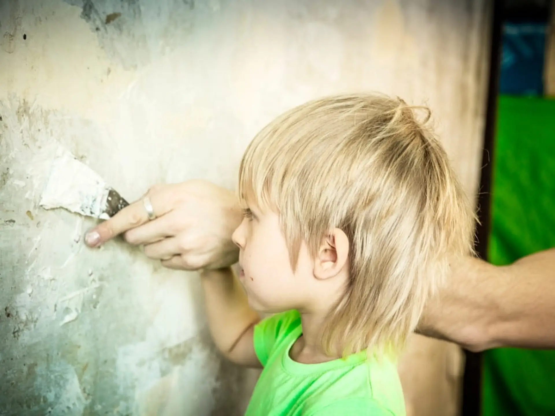 boy plastering wall with spackle