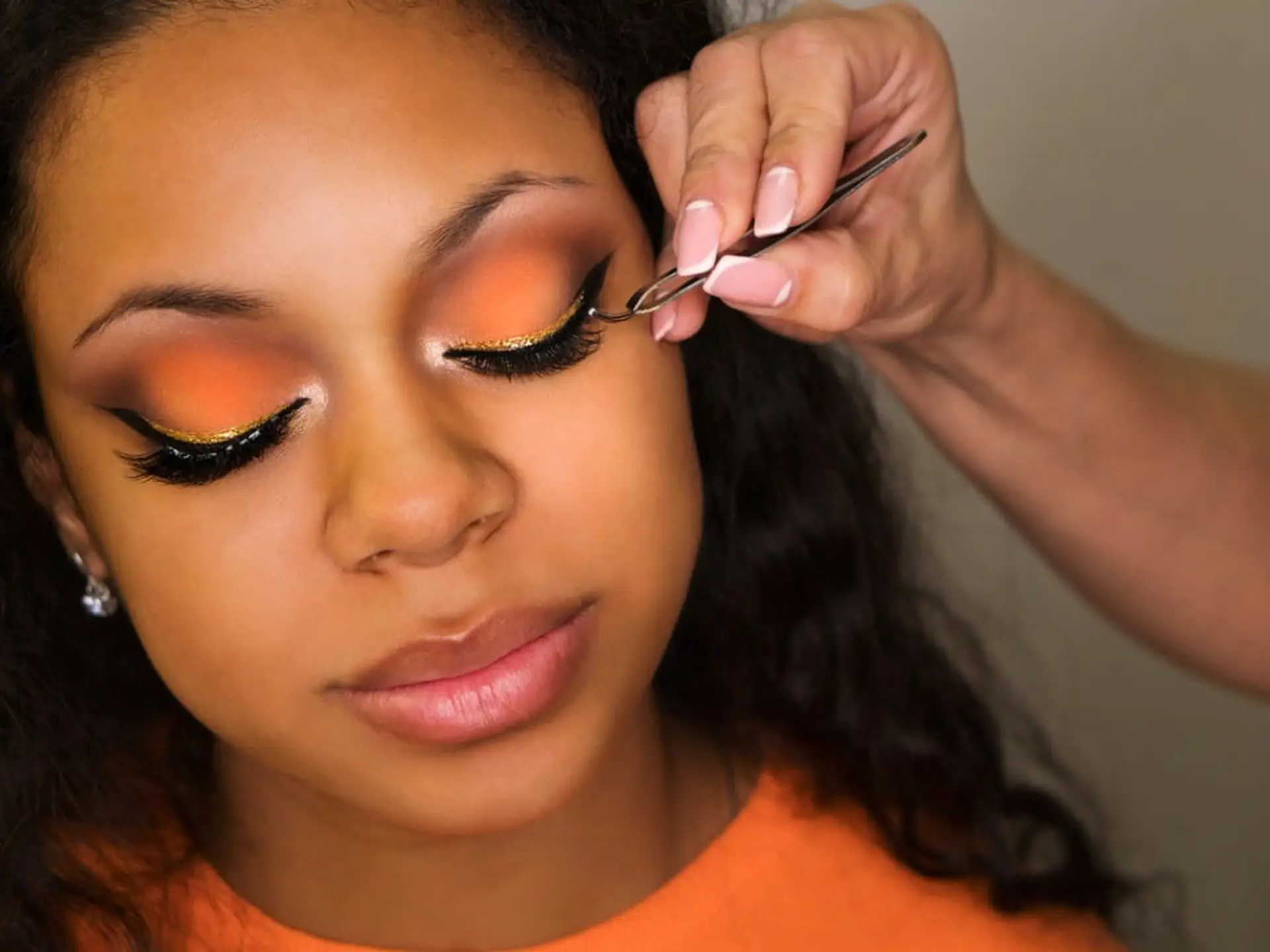 woman applying false lashes