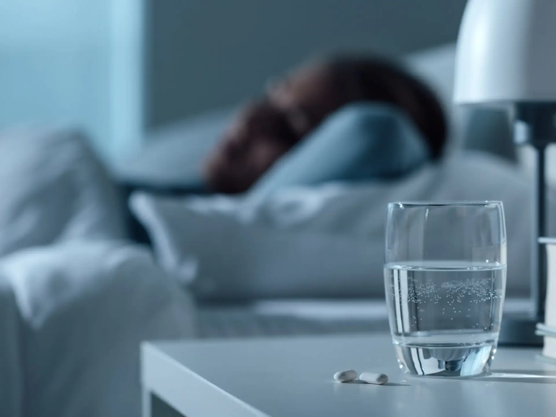 sleep meds woman sleeping with pills in foreground