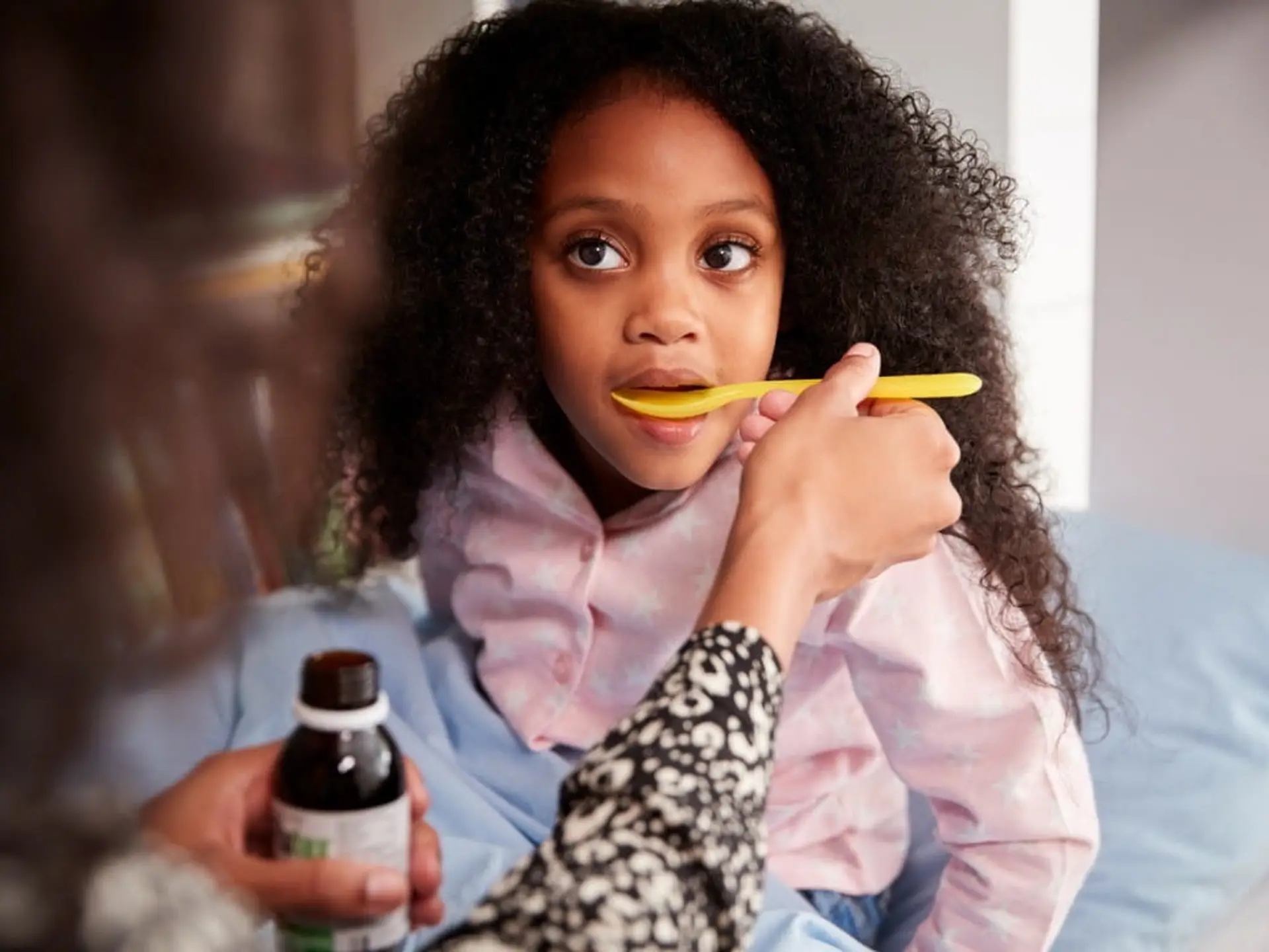 mother giving pinworm medicine