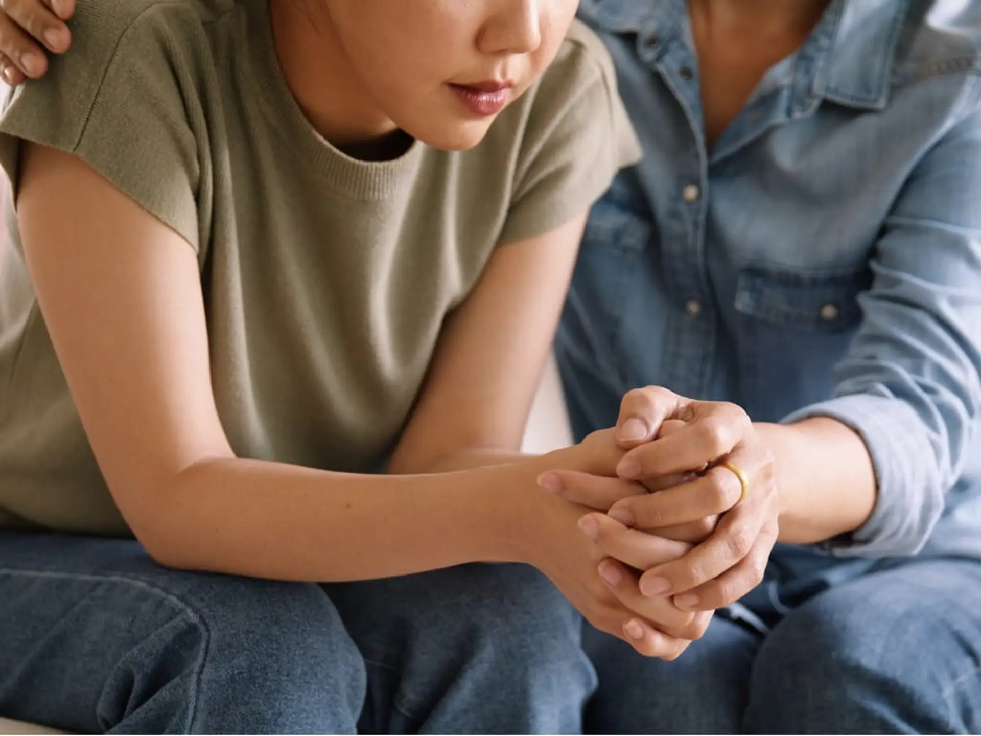 mother holding child's hand