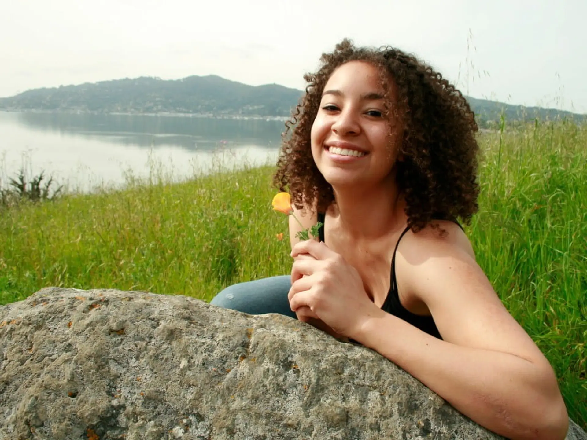 woman holding california poppy
