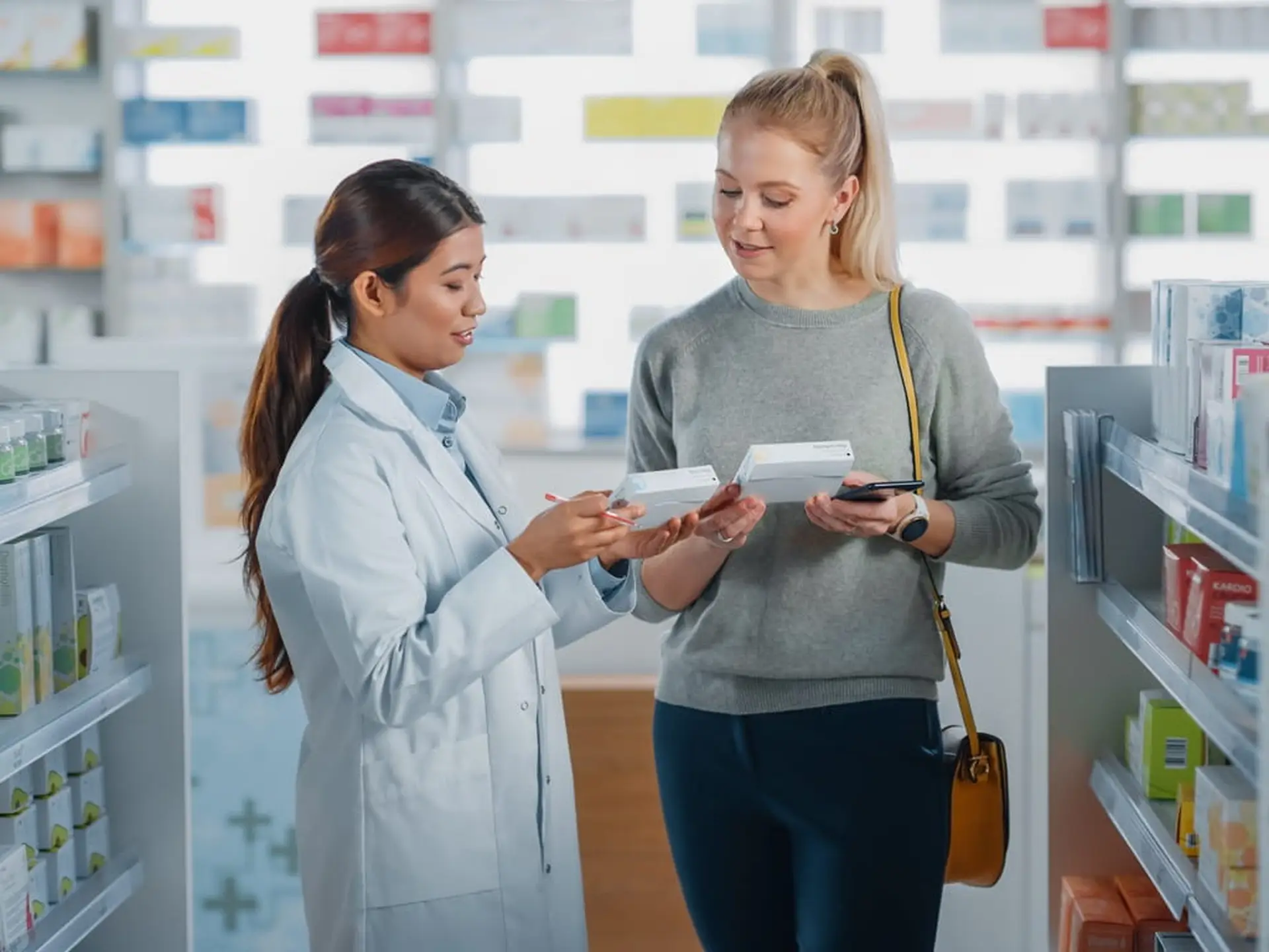 woman speaking with a pharmacist about medication