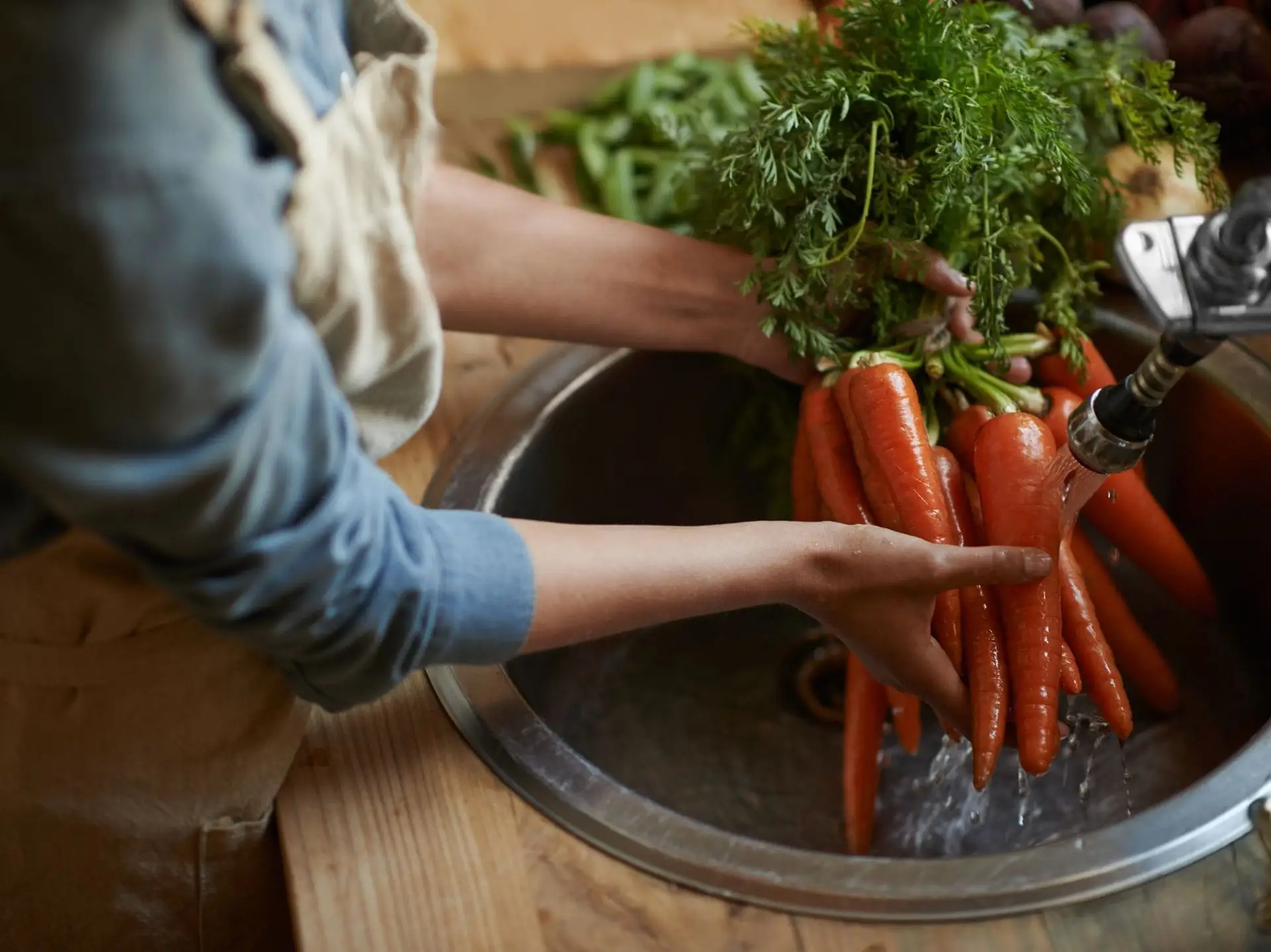 woman cleaning carrots
