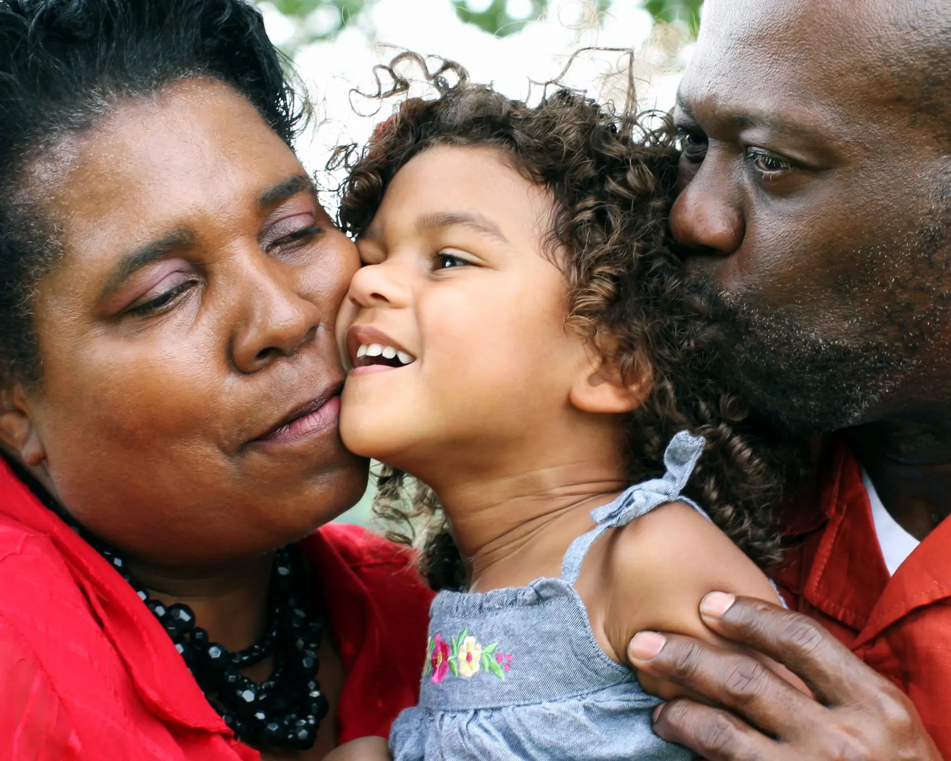grandparents holding their grandchild