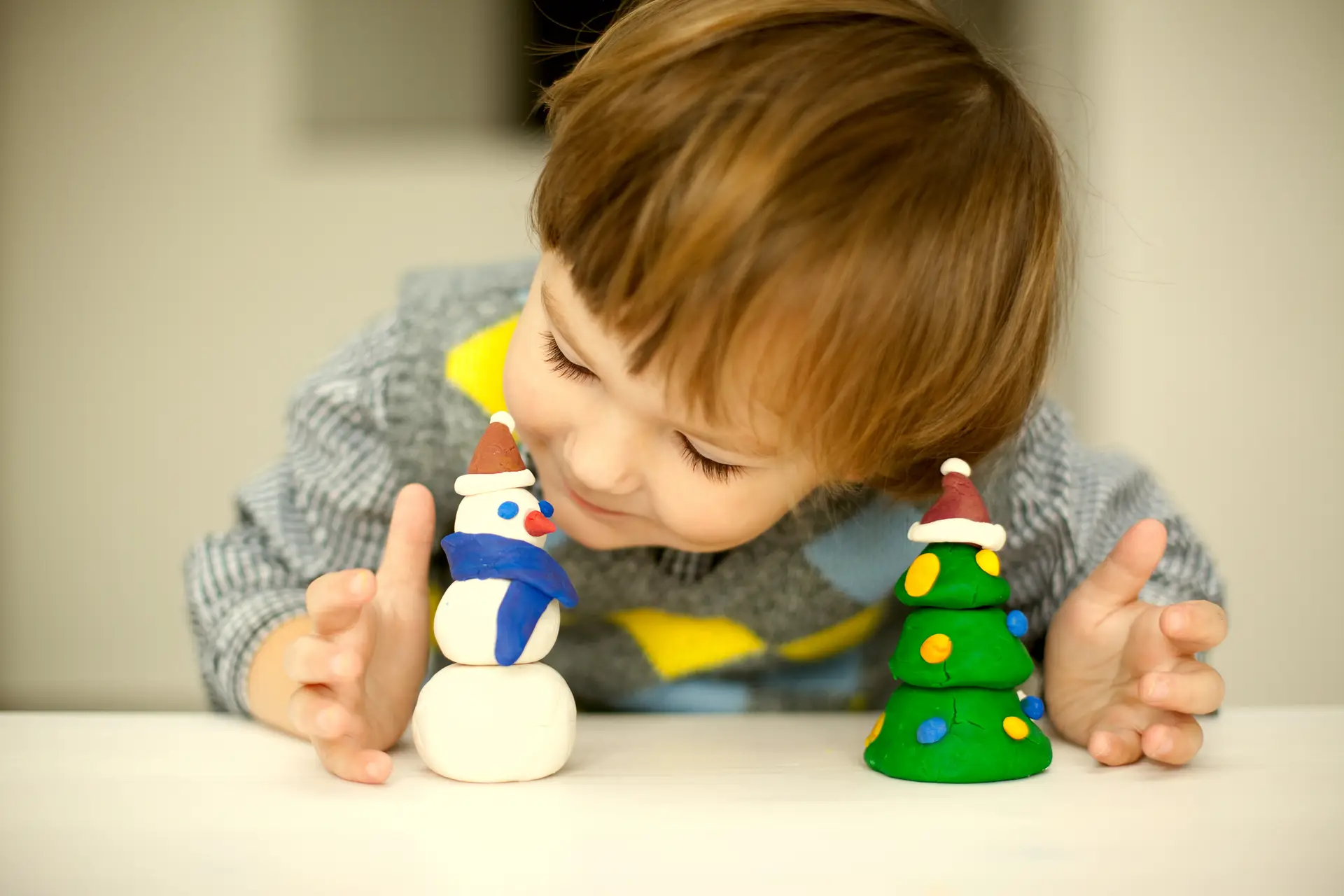 Kid playing with Christmas ornaments