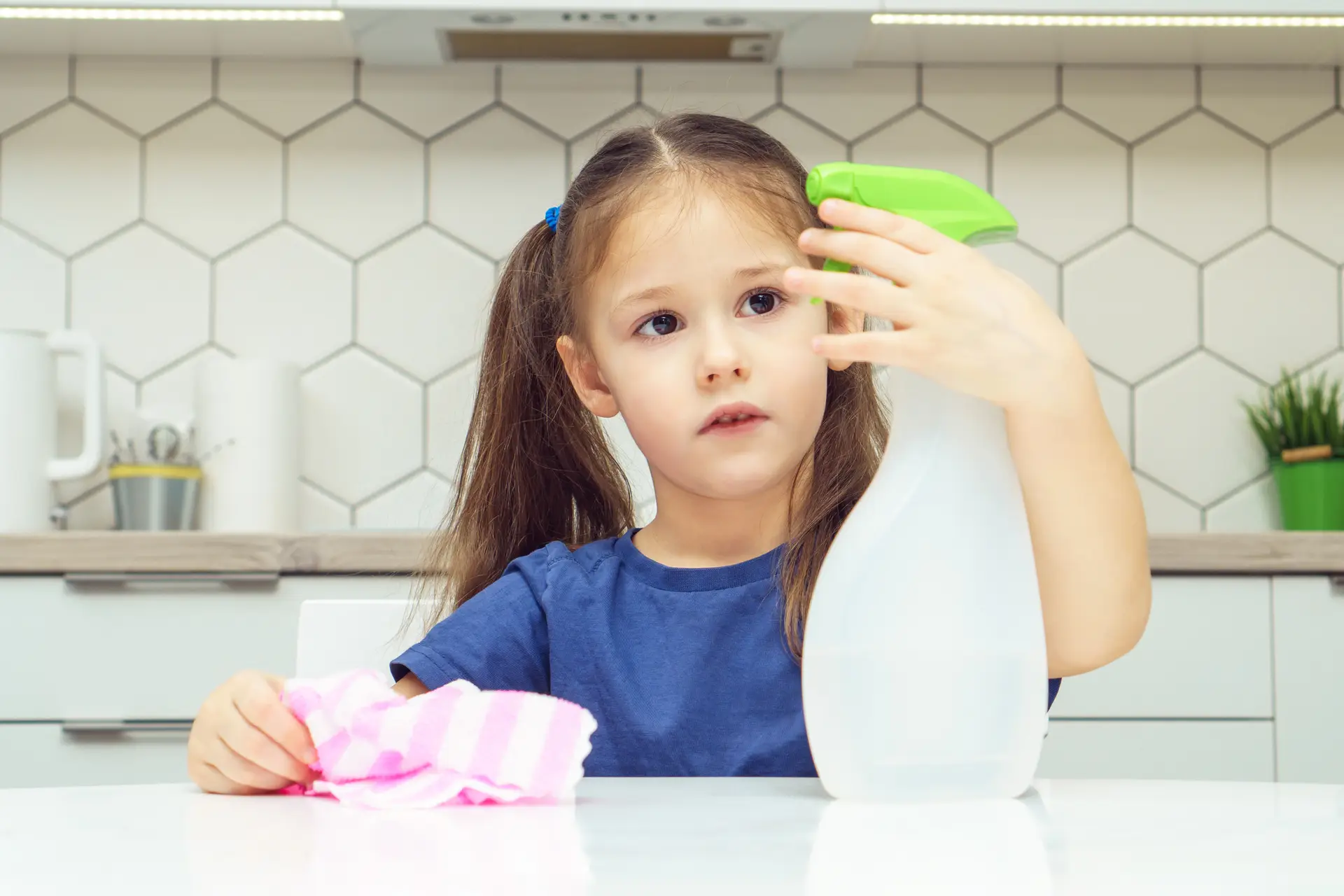 child holding a spray bottle