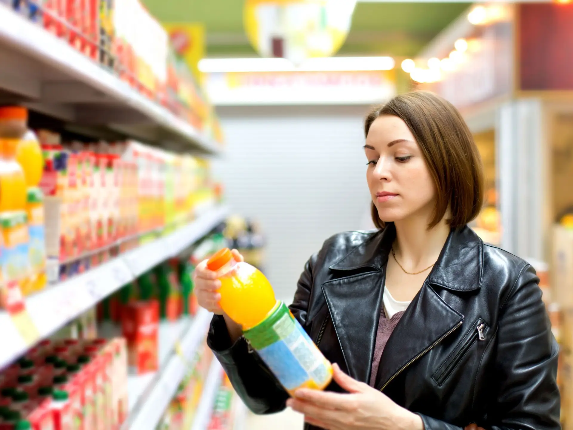 woman checking drink label