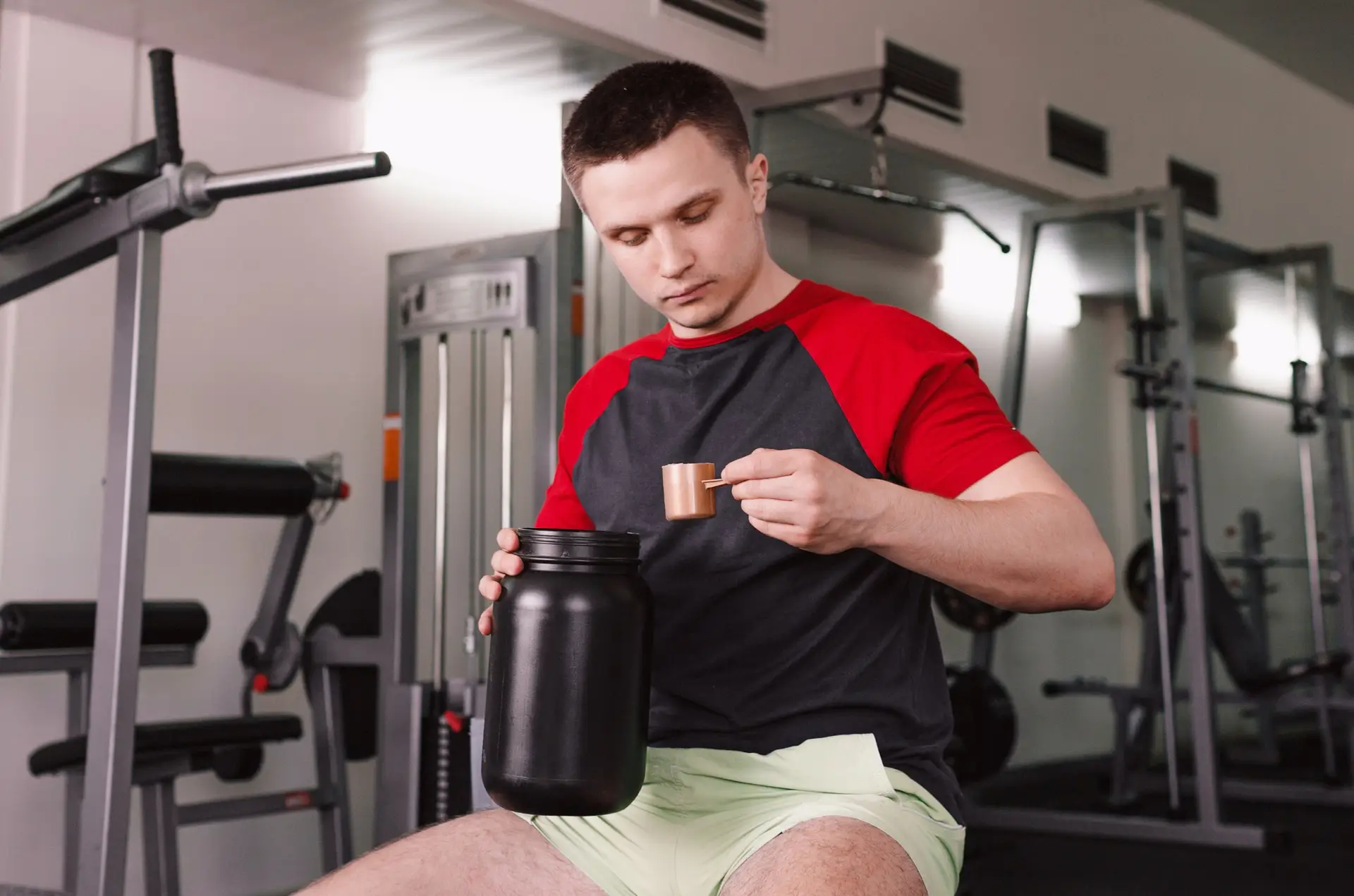 man in a gym dry scooping