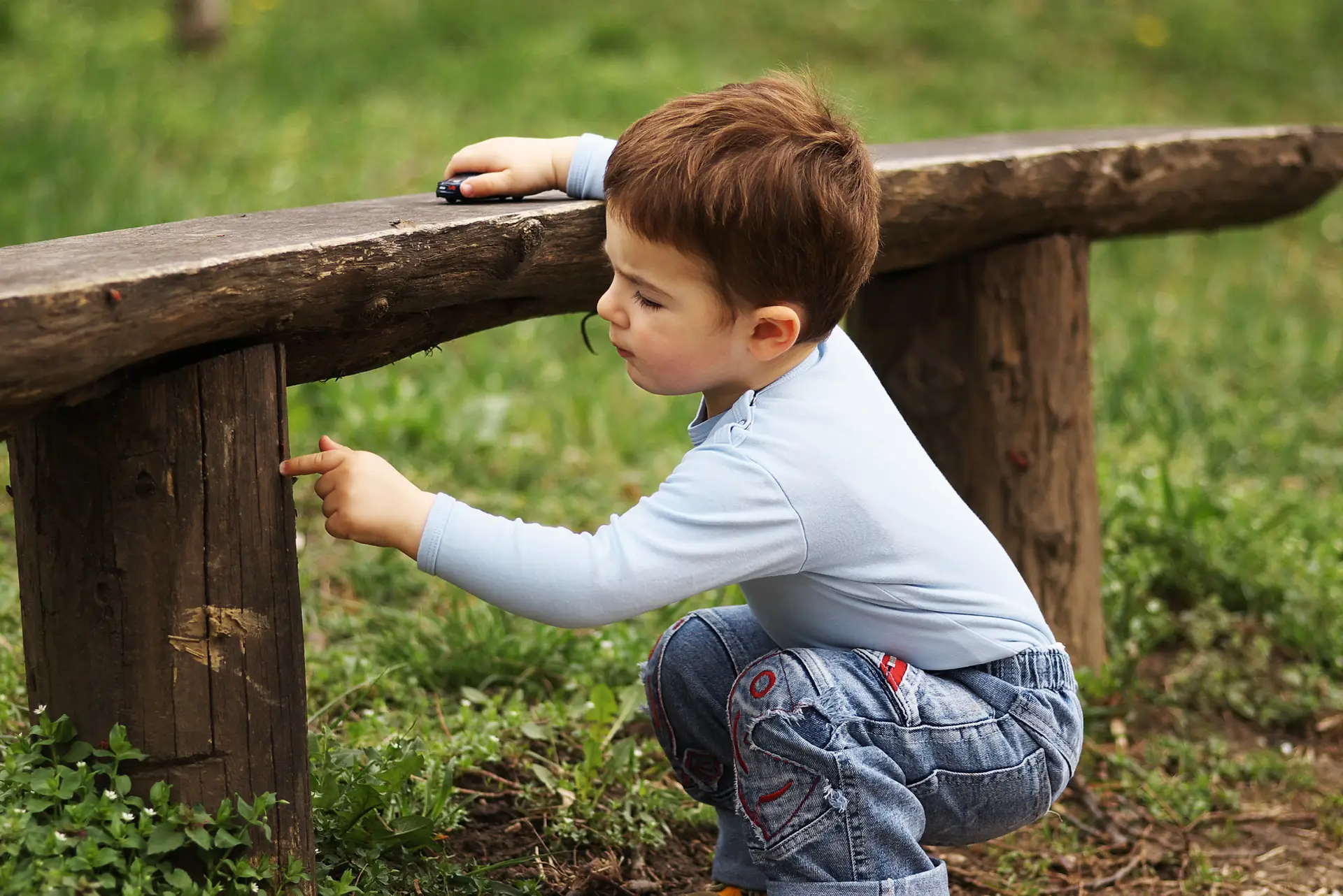 boy outside looking for bugs