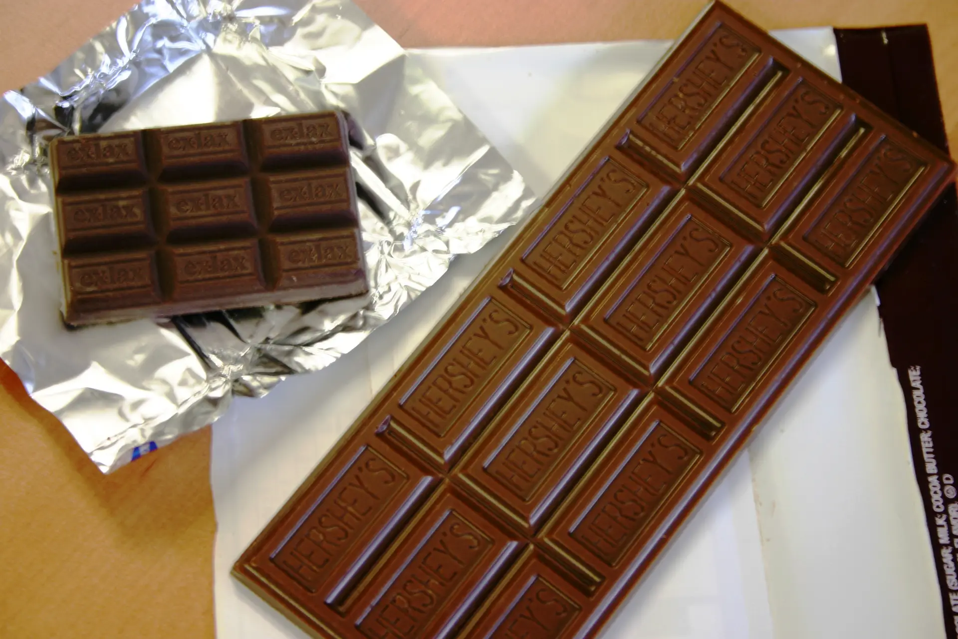 Bar of exlax chocolate next to a Hershey bar