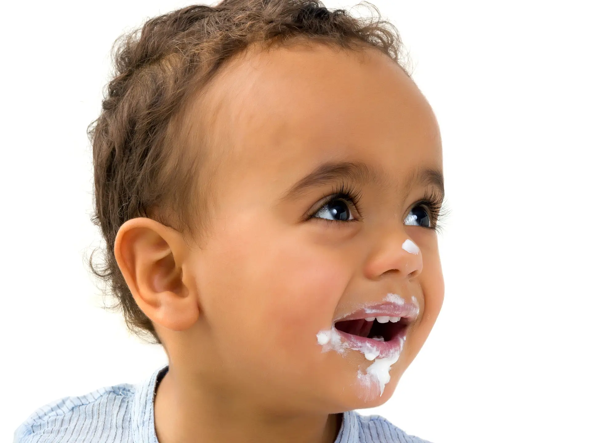 child with toothpaste on their face