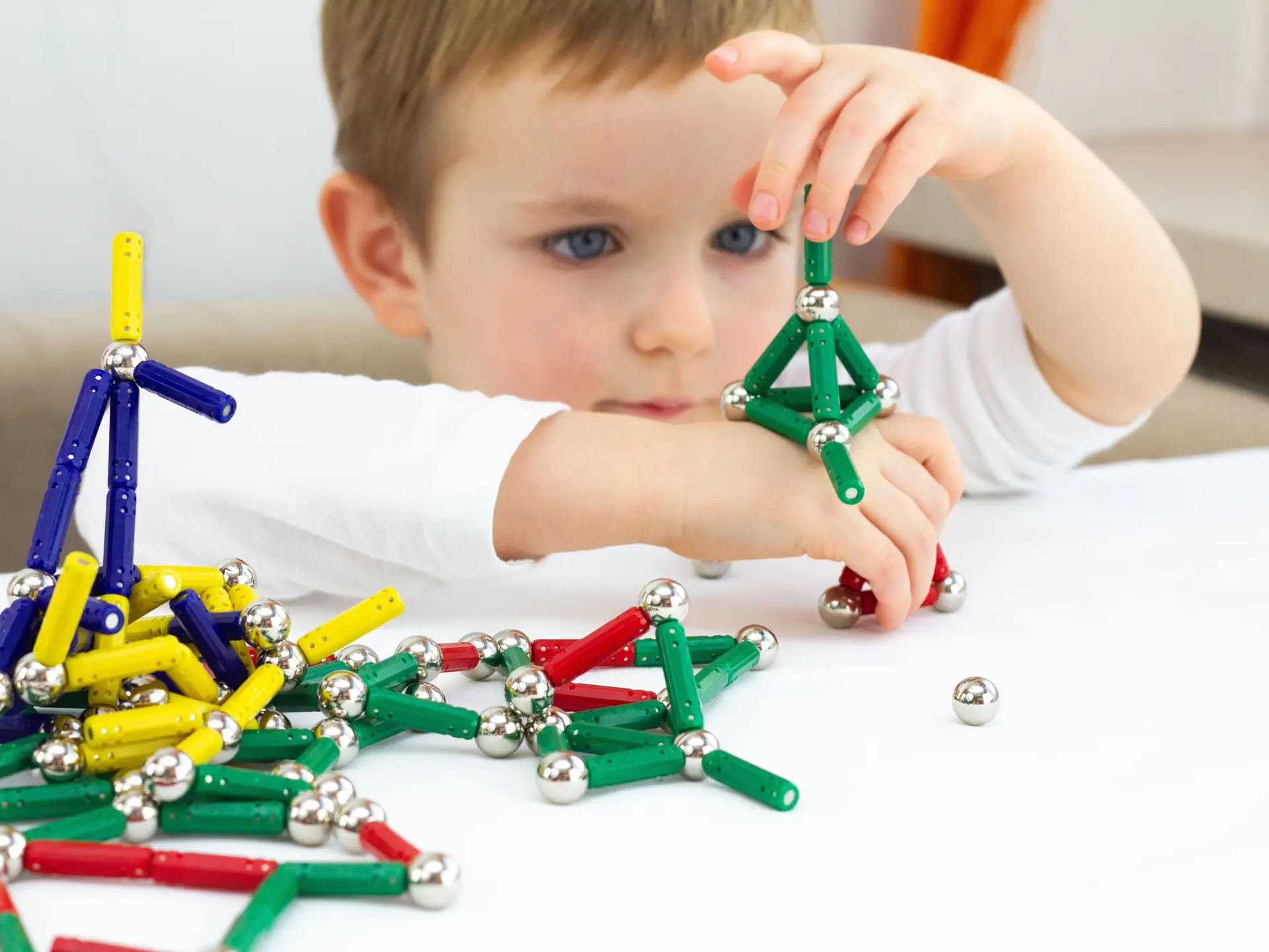 Boy playing with toy magnets