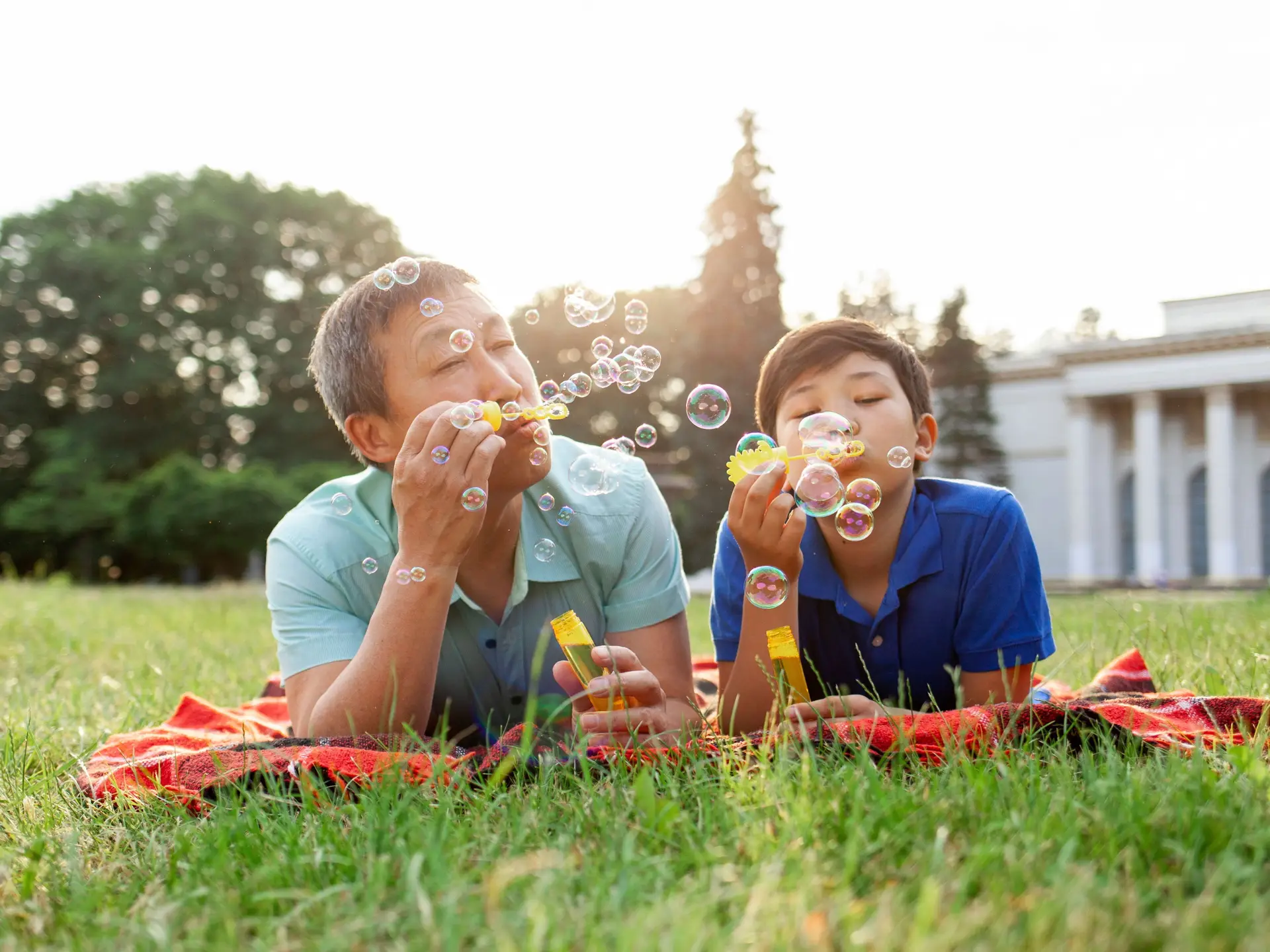 father and son blowing bubbles