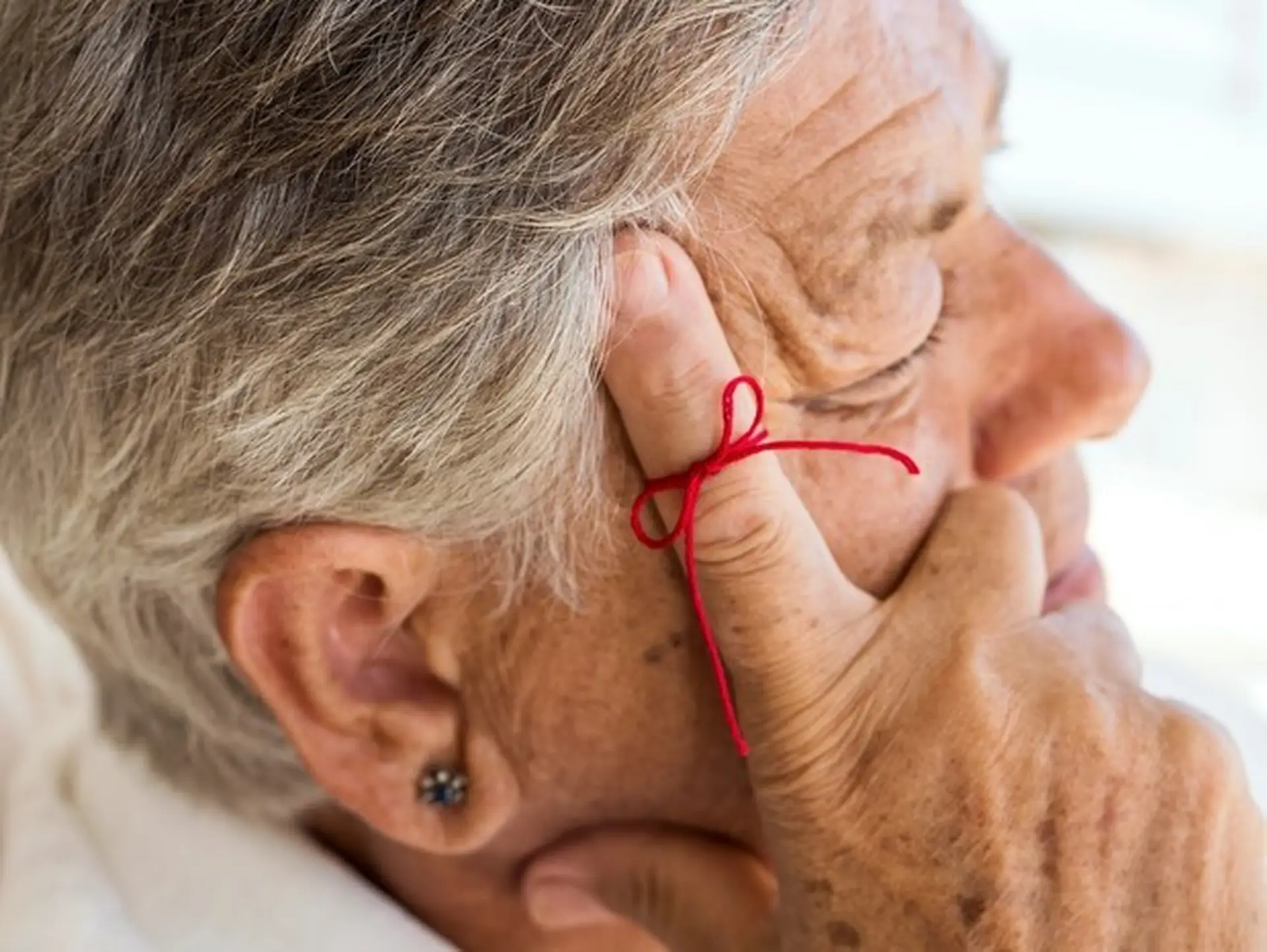 person with a string on their finger