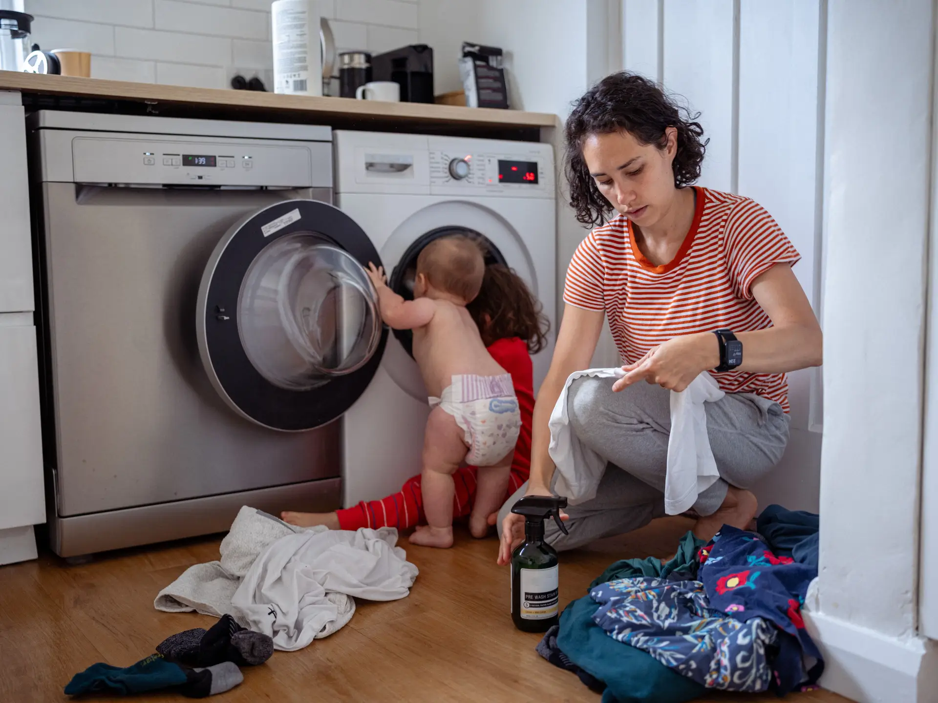 Mother doing laundry with toddler