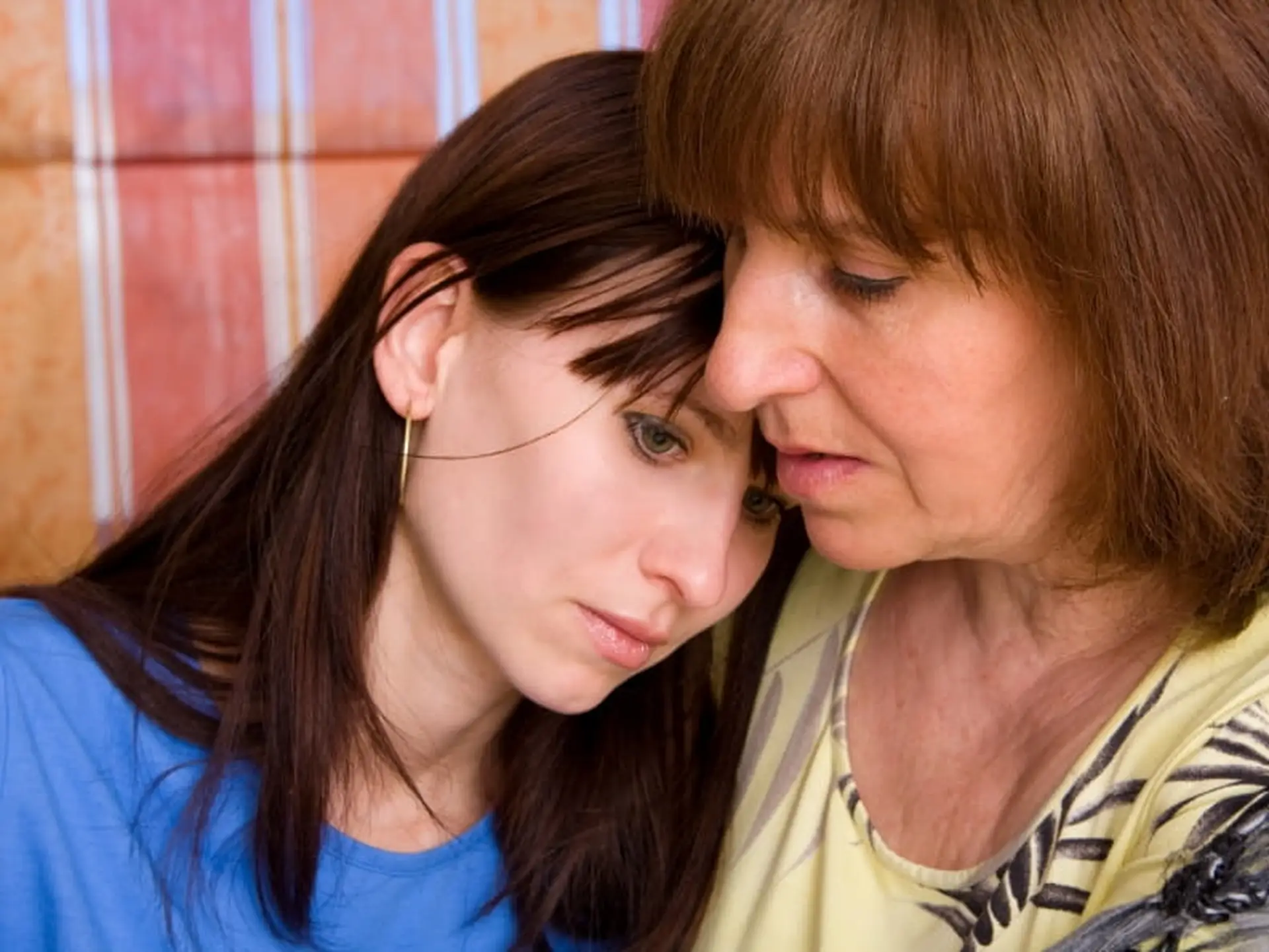 mother consoling daughter
